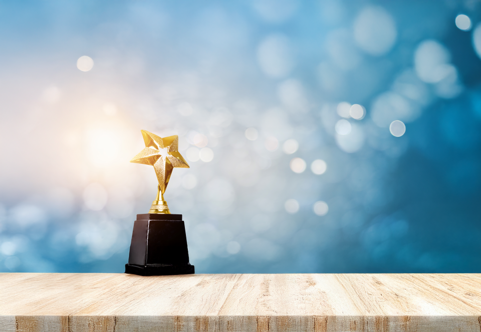 exp golden-trophy-award-bokeh-soft-blue-background-winner-1st-place-gold-trophy-award-concept 2